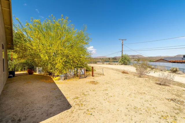 a view of a patio with table and chairs and potted plants