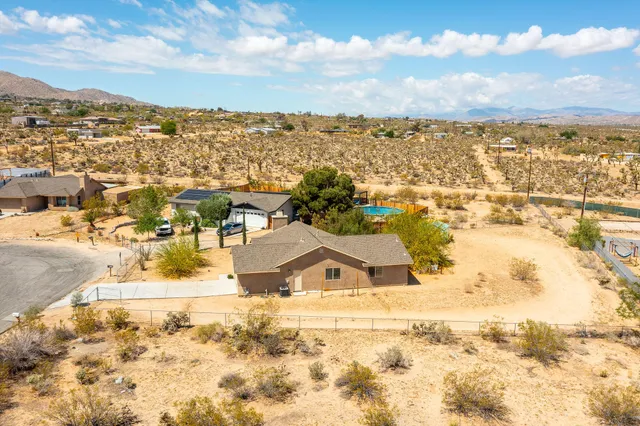 an aerial view of residential houses with outdoor space