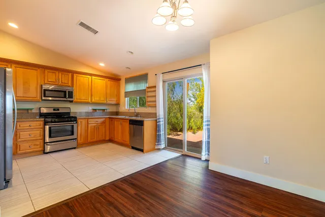 a kitchen with stainless steel appliances a refrigerator and a stove top oven