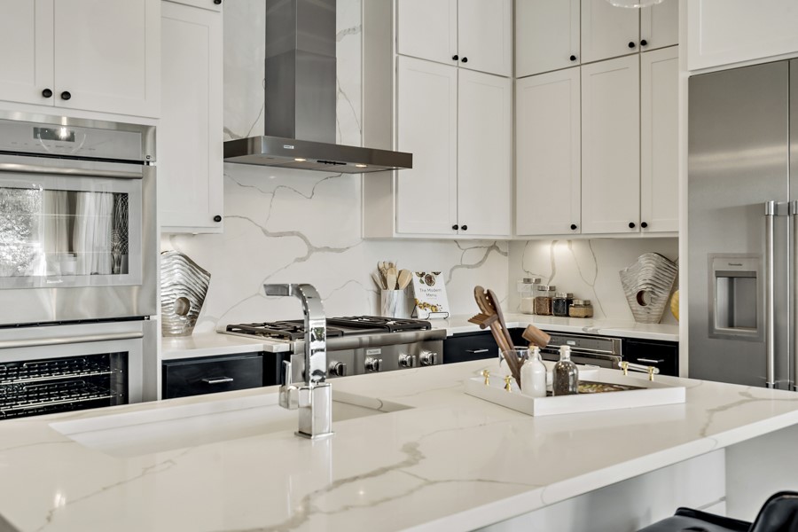 4206 Endurance Way Austin, TX 78731 - Photo 13 of 28 a kitchen with stainless steel appliances kitchen island granite countertop a stove and a refrigerator