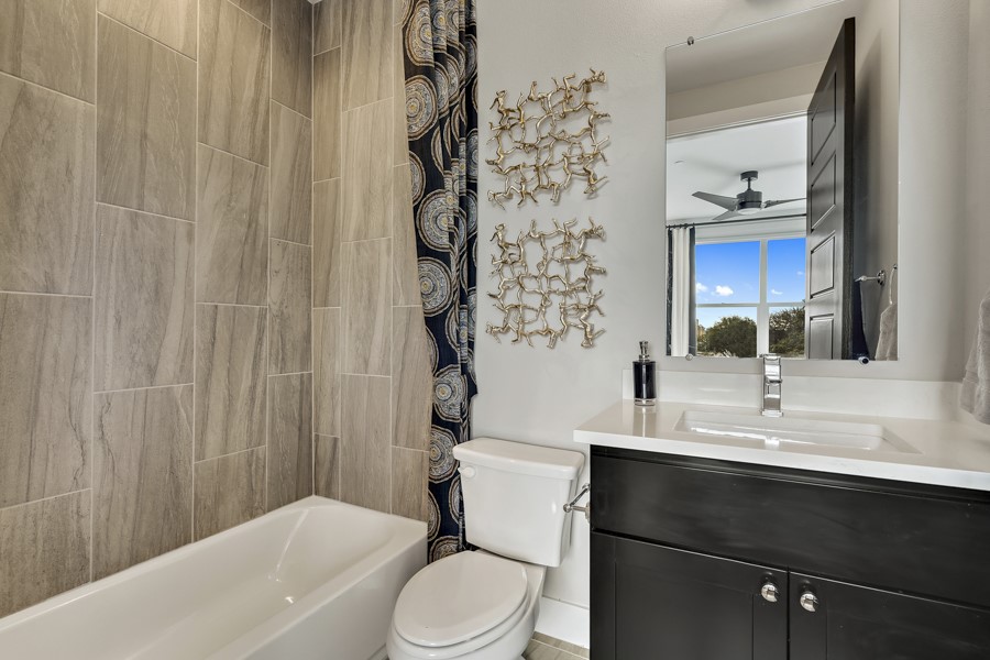 4206 Endurance Way Austin, TX 78731 - Photo 22 of 28 a bathroom with a sink a toilet and shower curtain