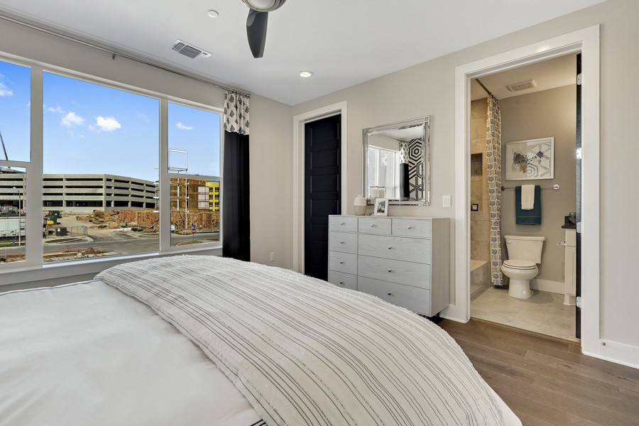 4206 Endurance Way Austin, TX 78731 - Photo 27 of 28 a spacious bedroom with a large bed and a large mirror