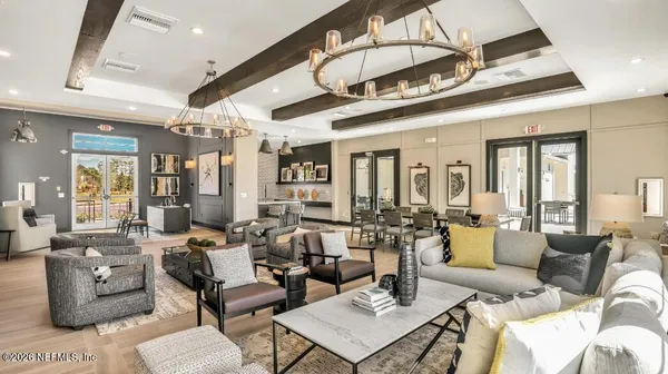 a very nice looking living room with furniture and a chandelier