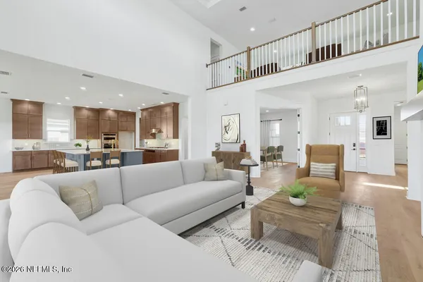 a living room with furniture kitchen view and a table