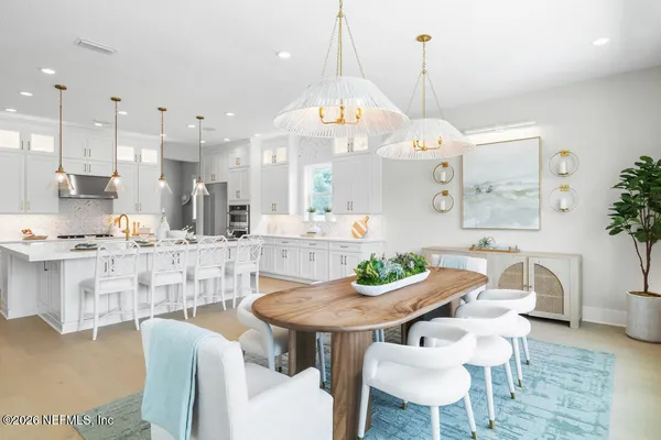 a view of a dining room with furniture and wooden floor