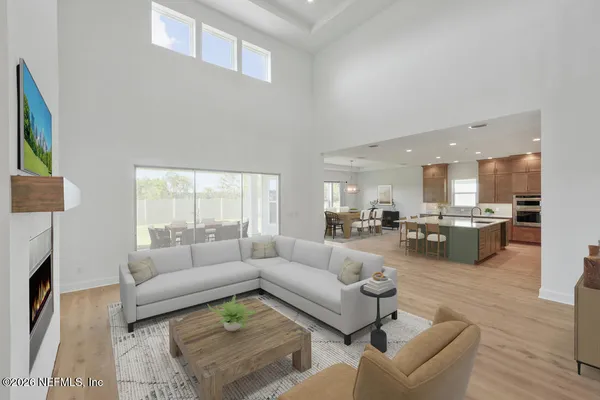 a living room with furniture and a view of kitchen