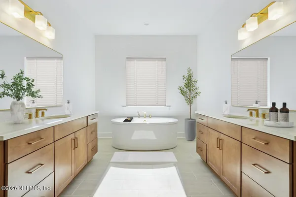 a spacious bathroom with a double vanity sink mirror and a bathtub