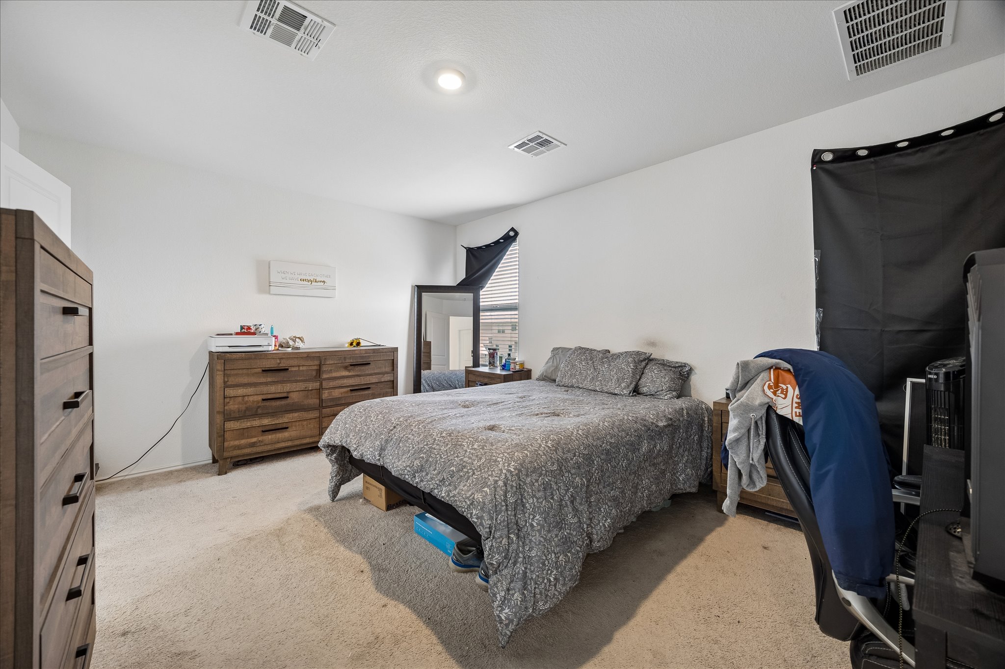 217 Canley Loop Hutto, TX 78634 - Photo 18 of 36 A well-lit bedroom offering a cozy retreat with neutral tones and ample space for relaxation.