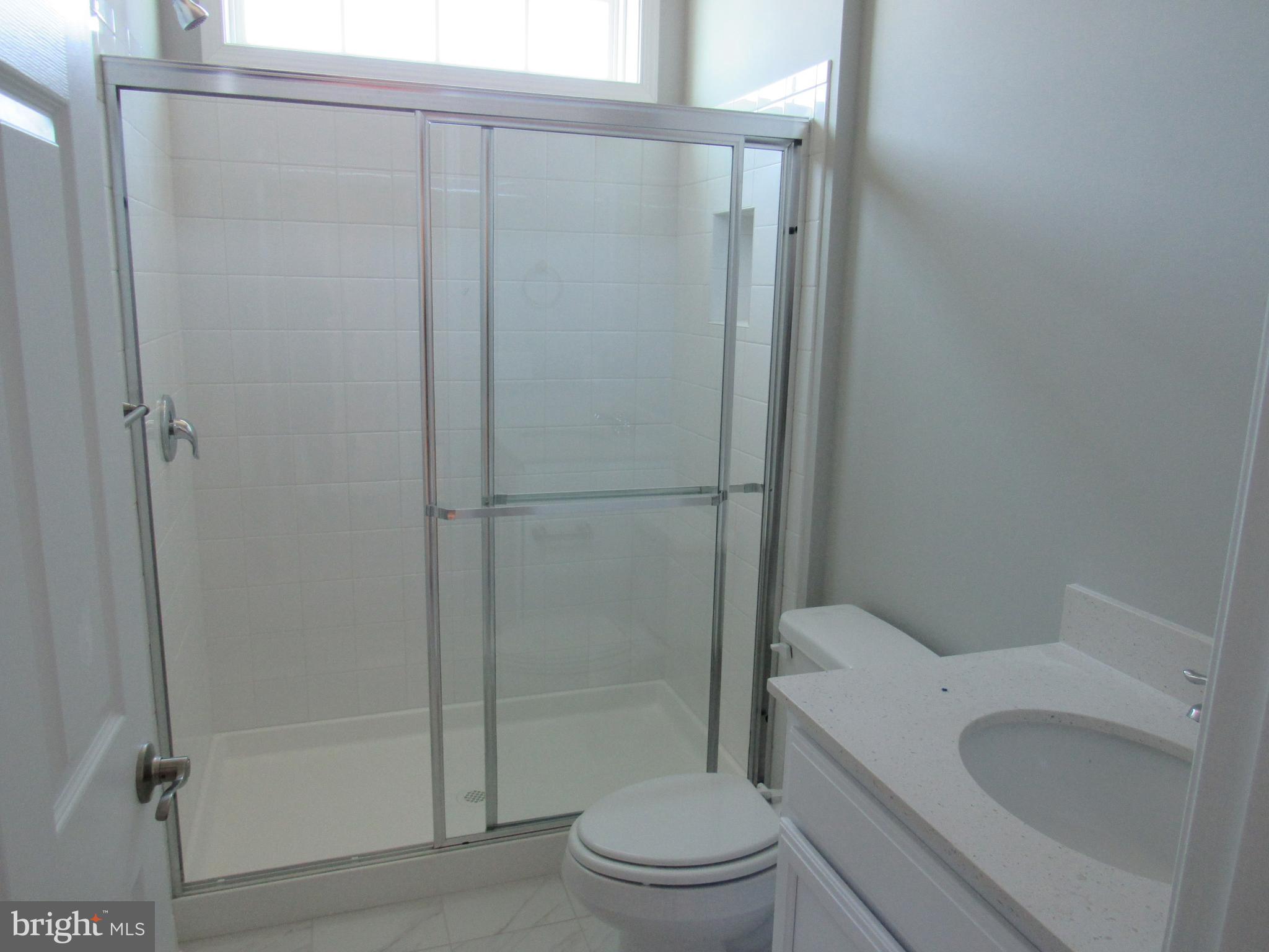 2 Patchy Way Lewes, DE 19958 - Photo 18 of 37 a white toilet sitting next to a bathroom sink