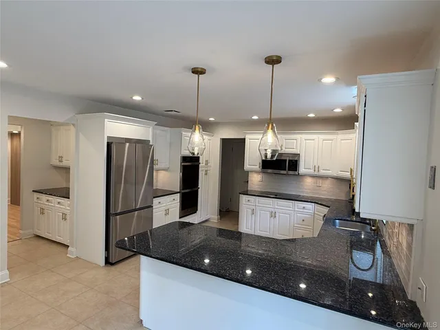 a view of a swimming pool with a patio and a yard