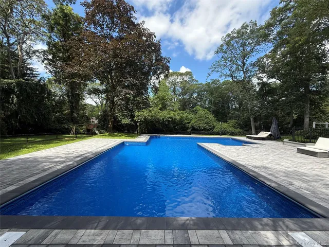 a picture of a room with a white wall and a refrigerator