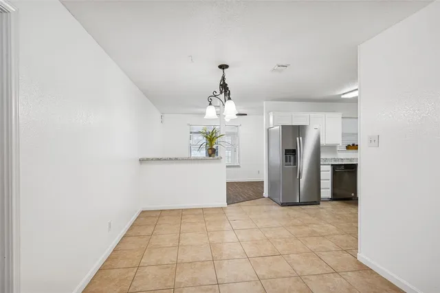 a kitchen with stainless steel appliances a refrigerator and microwave