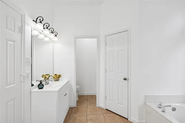 a bathroom with a bathtub sink and mirror
