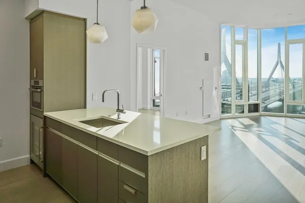 a kitchen with a sink a counter top space and cabinets