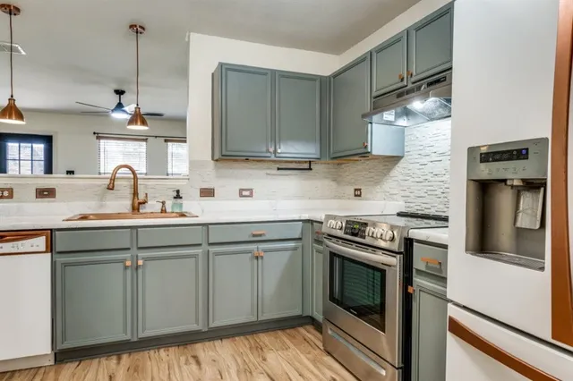 a kitchen with a sink stove and refrigerator