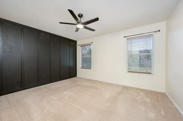 a view of a livingroom with a ceiling fan and window