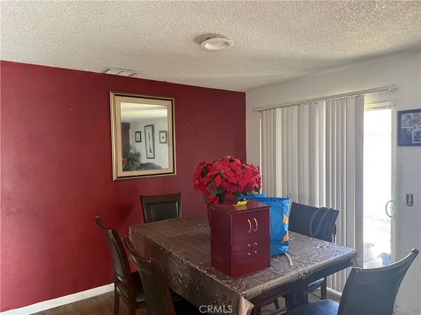 a view of a dining room with furniture and a window
