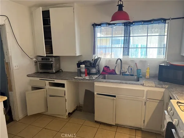 a kitchen with stainless steel appliances granite countertop a sink and a cabinets