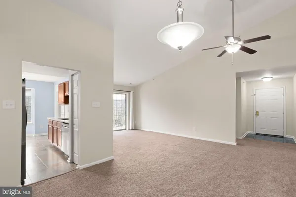a view of a chandelier fan and entryway