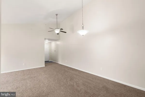 a view of a room with window and a ceiling fan