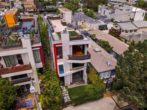 an aerial view of multiple houses with yard