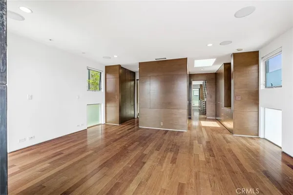 a view of empty room with wooden floor