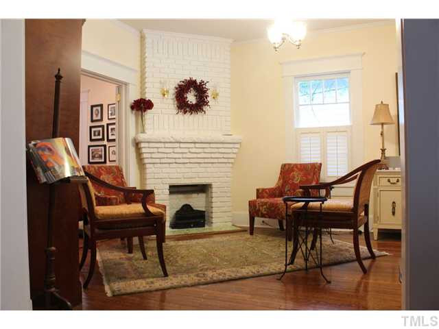 502 Cole Street Raleigh, NC 27605 - Photo 3 of 25 Living room has pretty hardwoods and a coal basket gas log set.