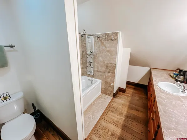 a bathroom with a sink toilet and shower