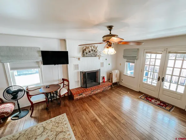 a living room with furniture fireplace and flat screen tv