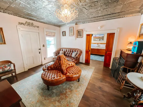 a living room with furniture rug and wooden floor
