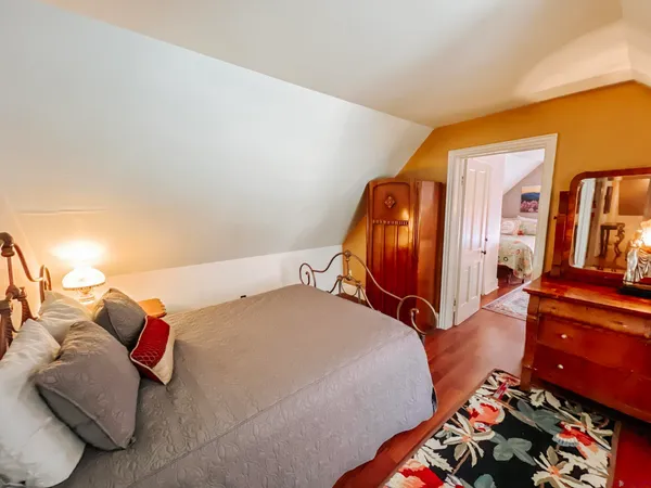 a bed room with a bed and a dresser