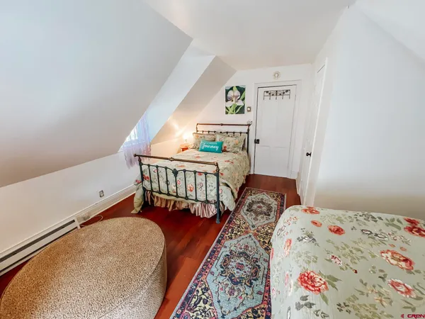 a bedroom with two beds and a window