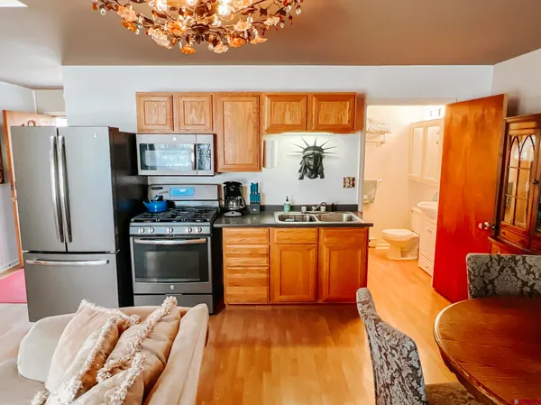 a kitchen with stainless steel appliances granite countertop a refrigerator sink and stove