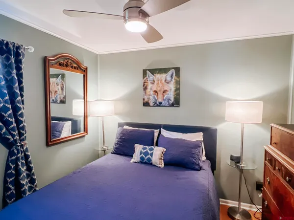 a bed room with a bed and a painting on the wall