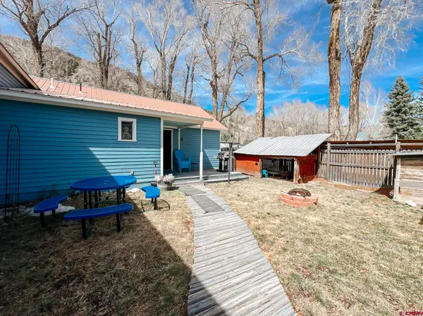 a wooden bench sitting in front of a house