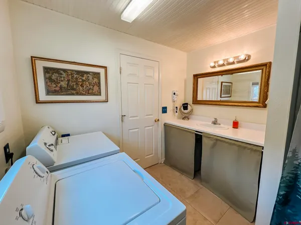 a utility room with a sink dryer and washer