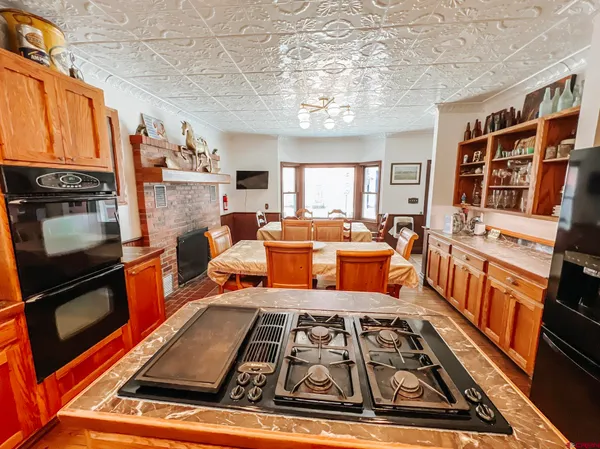 a living room with patio fireplace furniture and a rug