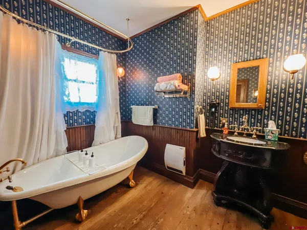 a bathroom with a sink mirror and toilet