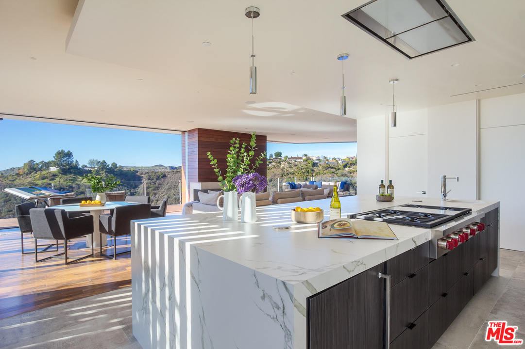 1979 Stradella Road Los Angeles, CA 90077 - Photo 8 of 38 a kitchen with stainless steel appliances granite countertop a sink and a stove