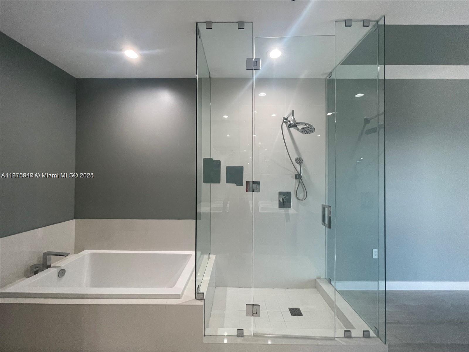 55 Southwest 9th Street, Unit 4304 Miami, FL 33130 - Photo 11 of 32 a bathroom with a bathtub and shower