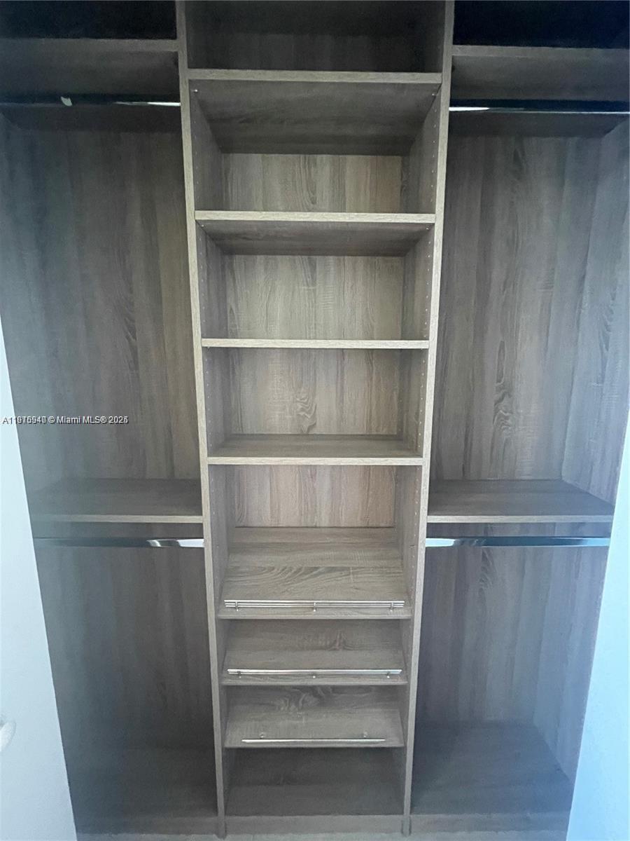 55 Southwest 9th Street, Unit 4304 Miami, FL 33130 - Photo 14 of 32 a view of walk in closet with empty racks