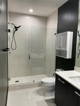 a white toilet sitting next to a bath tub