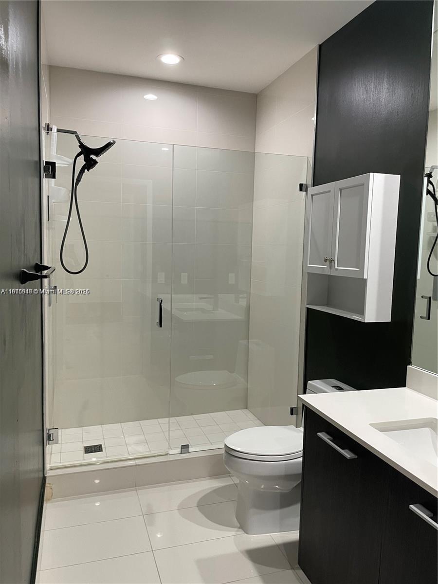 55 Southwest 9th Street, Unit 4304 Miami, FL 33130 - Photo 18 of 32 a bathroom with a sink a toilet and shower