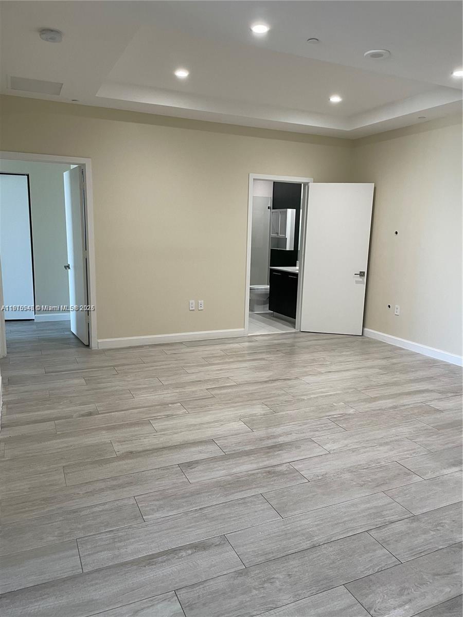 55 Southwest 9th Street, Unit 4304 Miami, FL 33130 - Photo 21 of 32 an empty room with wooden floor and windows