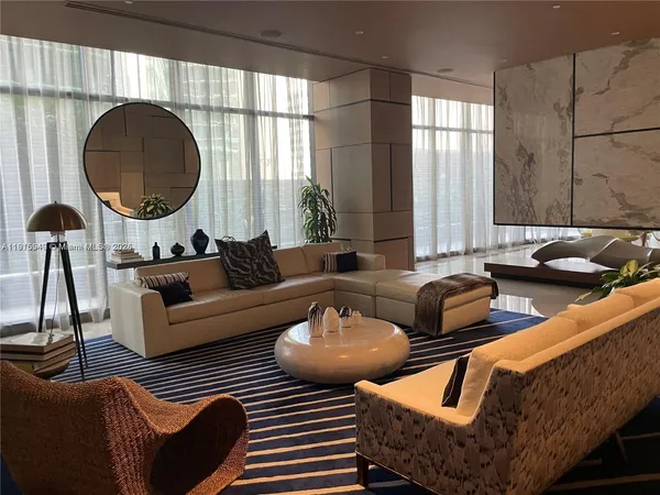 a living room with furniture and kitchen view