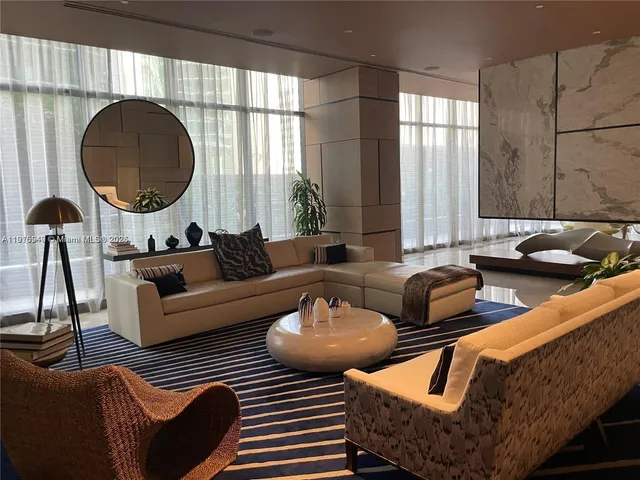 a living room with furniture and kitchen view