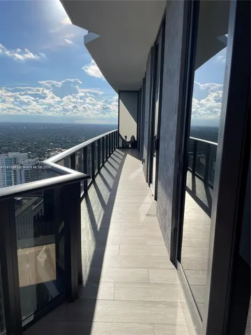 a view of a balcony with wooden floor