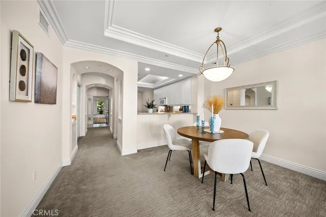 a view of a livingroom with furniture a chandelier and wooden floor