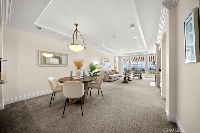 a living room with furniture a window and a chandelier
