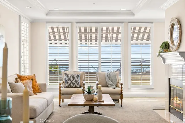 a living room with furniture and floor to ceiling windows